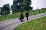 Amish boys with scooter and buckets by Dennis L. Hughes