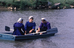 Amish women in row boat by Dennis L. Hughes