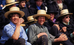 Young Amish men watch four corner ball by Dennis L. Hughes