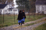 Amish girls walking along road by Dennis L. Hughes