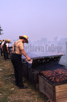 Amish men barbecuing chicken by Dennis L. Hughes