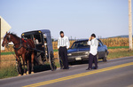 Orthodox Jewish tourists visit with Amish man by Dennis L. Hughes