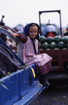 Amish girl on edge of wagon by Dennis L. Hughes