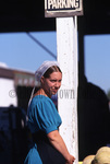 Young Amish woman at produce auction by Dennis L. Hughes