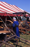 Amish woman looking at buggies by Dennis L. Hughes