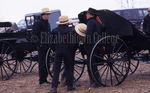 Young Amish men near buggies by Dennis L. Hughes