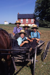 Amish boys in open buggy by Dennis L. Hughes