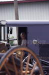 Amish boy in parked buggy by Dennis L. Hughes