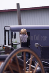 Small Amish boy entering buggy by Dennis L. Hughes