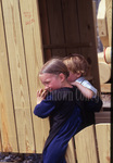 Amish children enter wooden buggy by Dennis L. Hughes