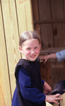 Amish girl smiling by Dennis L. Hughes