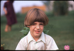 Amish boy with flowers by Dennis L. Hughes