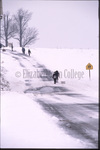 Amish children walk in snow by Dennis L. Hughes