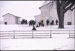 Amish children play in snow by Dennis L. Hughes