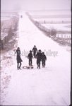 Amish children walk down road in snow by Dennis L. Hughes
