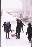 Amish children on snowy road by Dennis L. Hughes