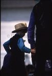 Amish boy holding man’s hand by Dennis L. Hughes