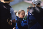 Amish girl looking into camera by Dennis L. Hughes