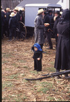 Amish child stands in crowd by Dennis L. Hughes