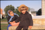 Amish children sitting by Dennis L. Hughes