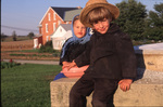 Amish children look into camera by Dennis L. Hughes